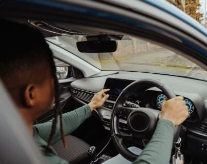 A guest at the wheel during a hire